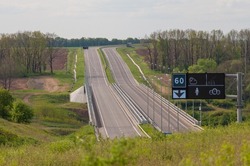 Highway with ascent and descent, bumpers, road signs and an electronic board.