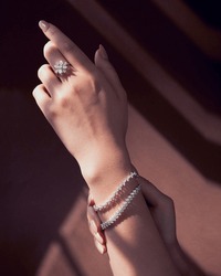 beautiful model wearing white gold diamond ring and tinnes bracelets.