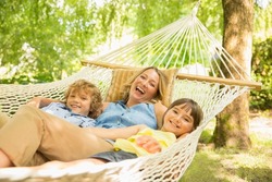 Mother and children relaxing in hammock