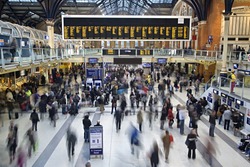 Liverpool street station in the UK at rush hour with all faces blurred out and logos/trademarks removed