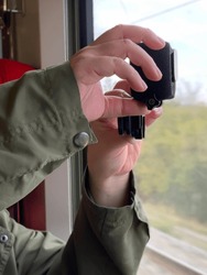 Close up of hand holding camera while capturing beautiful view, Amsterdam, Netherlands.