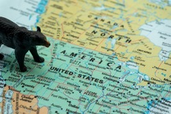 A black bear placed on a map of the United States. a bear market, a fall in the stock market. Economic downturn, financial crisis.bearish.down trend investment,US stocks