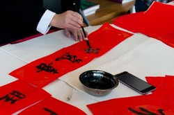 People in China write Spring Couplets to celebrate Chinese New Year. Chinese calligraphy characters meaning good luck and blessings.Handwritten.happy