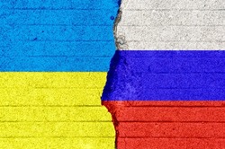 The Russian and Ukrainian flags are printed on the cracked floor. Ukraine crisis. Border conflict. International situation themes, peace and war.political confrontation.Diplomatic relations.