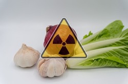vegetables with radiation warnings.contaminated foods.Radioactive soil.metaphor for nuclear threat.Nuclear leak,Environmental damage.white background.