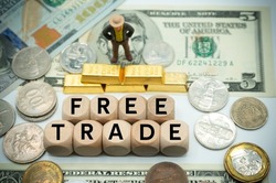 free trade is the opposite of trade protectionism or economic isolationism.free agreement.laissez-faire trade or trade liberalization.The word is written on  money and gold background