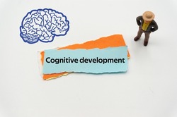 Cognitive development.The word is written on a slip of colored paper. Psychological terms, psychologic words, Spiritual terminology. psychiatric research. Mental Health Buzzwords.