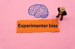 Experimenter bias.The word is written on a slip of colored paper. Psychological terms, psychologic words, Spiritual terminology. psychiatric research. Mental Health Buzzwords.