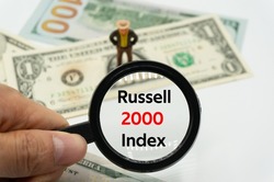 Russell 2000 Index.Magnifying glass showing the words.Background of banknotes and coins.basic concepts of finance.Business theme.Financial terms.