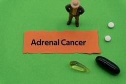 Adrenal Cancer.The word is written on a slip of colored paper. health terms, health care words, medical terminology. wellness Buzzwords. disease acronyms.
