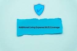 Additional Living Expense ALE Coverage.The word is written on a slip of colored paper. Insurance terms, health care words, Life insurance terminology. business Buzzwords.