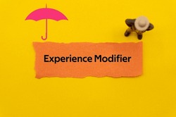 Experience Modifier.The word is written on a slip of colored paper. Insurance terms, health care words, Life insurance terminology. business Buzzwords.