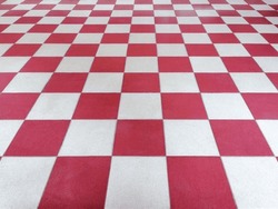 Red and white tiled floor symmetrical with grid texture in perspective view for background.Permanent tiled floor. red white square Made of floor ceramic material