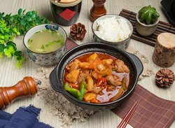 Xinjiang Dapan Chicken with rice and soup isolated on mate top view of chinese food table
