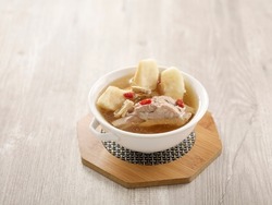 Double-boiled Spare Rib Soup with Chinese Yam and Snow Pear with chopsticks served in a dish isolated on mat side view on grey background