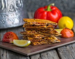 Spicy arrayes served in wooden board side view on wooden table background