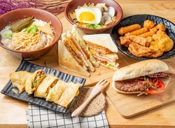 Assortment of Beef Crispy Egg Cake, Peeled Pepper Noodles, Deluxe fried food platter, Spicy Chicken Chop Sandwich, fried instant noodles, served in a dish isolated on table top view of chinese food