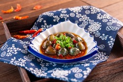 Spicy chilli Hunan style preserved egg with sauce served dish isolated on wooden table top view of Hong Kong food