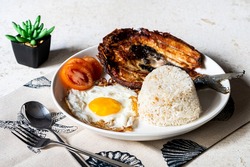 Daingsilog- is a famous Filipino meal can be eaten as breakfast lunch or even dinner and is  composed of boneless fried milkfish, fried egg, and garlic rice. 