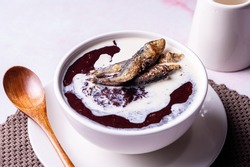 Champorado or tsampurado is a sweet chocolate rice porridge in Philippine cuisine. Topped with evaporated milked and dried fish