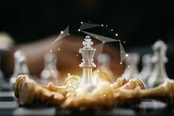 Close-up of a game of chessboard with chess pieces. Chessboard Concept vs. Business Management on Risk, Graphic Charts Showing Financial Flows and Business Performance. Risk management.