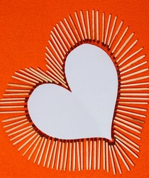 white figure of heart, lined with whole matches on yellow orange background. white heart core for text. Selective focus. international match day. Unity, Commonwealth, Peace. design