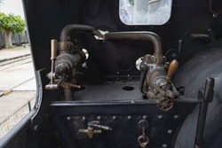 Black pressure gauge of an old steam engine in the train engine room