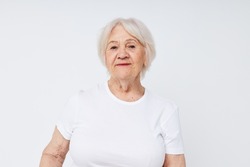 close-up of a cheerful elderly woman in a white t-shirt