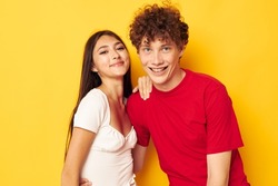portrait of a man and a woman together posing emotions close-up yellow background unaltered