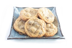 Fresh Homemade Chocolate Chip Cookies on Square Blue Pottery Plate Isolated on White