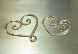 Hearts formed of Sterling Silver Wire by Handmade Artisan Placed on Silver Sheet Metal