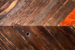 Rough diagonal wood background with knothole - vertical -natural colors with redish plank