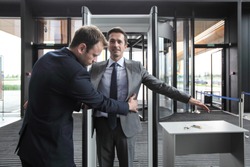 Security man check businessman at entrance in office building or airport