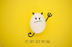 Funny evil egg character on yellow background