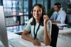 You havent heard quality until youve called us. Portrait of a young woman using a headset and computer in a modern office.