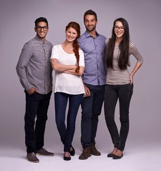 The team you can depend on. Studio shot of a group of diverse young people against a gray background.