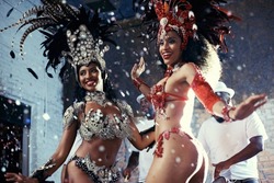 Samba. Shot of two beautiful samba dancers performing in a carnival.