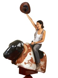 Yeehaw. Studio shot of a beautiful young woman riding a mechanical bull against a white background.