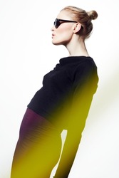 Streaks of style and light. Studio shot of stylish model highlighted with streaks of color isolated on white.