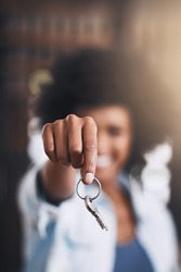 The keys to freedom. Cropped shot of a young woman holding house keys in her new home.