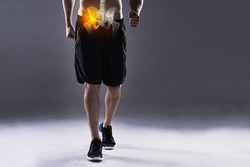 Carrying a hip injury. Cropped shot of a young man in the studio with cgi highlighting his hip injury.