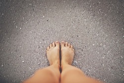 If youre wearing shoes, youre overdressed. High angle shot of a womans feet at the beach.