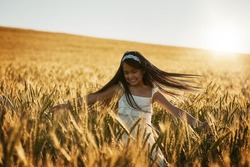 Shes Mother Natures favourite child. Shot of a cute little girl twirling in a cornfield.