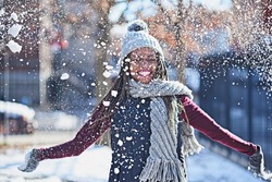 Snow is a celebration of life. Shot of a happy young woman throwing snow on a wintery day outdoors.