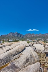 Low angle view of the Twelve Apostles mountain range in South Africa against a blue sky. Closeup of rocky landscape below a popular tourism attraction. Remote travel location near table mountain