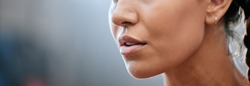 Closeup banner of a womans face, mouth and chin with blurred copy space. Young female looking confident, focused and determined. Breathing deeply while getting ready and preparing for a challenge