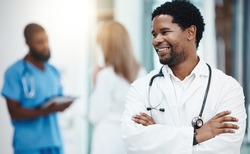 Smile black man, happy healthcare doctor and hospital worker with motivation, trust and expert advice in clinic. Professional african medic, surgeon and medical therapist working with wellness vision