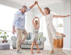 Girl dance with grandparents on living room, have fun and happy time in home. Senior man, smile in house with woman and child, dancing and playing together in their lounge at family home