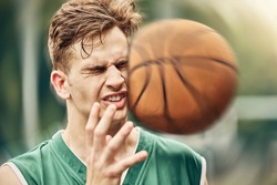 Sports, basketball and accident with face in game match on athlete court for tournament training. Injured man in professional outdoor fitness centre in pain from impact of ball hit action.