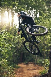 Mountain biking, forest and freedom while on a bicycle and cycling outside in nature for exercise, adrenaline and skill. Fitness, health and an active man cycling on an outdoor adventure in Norway